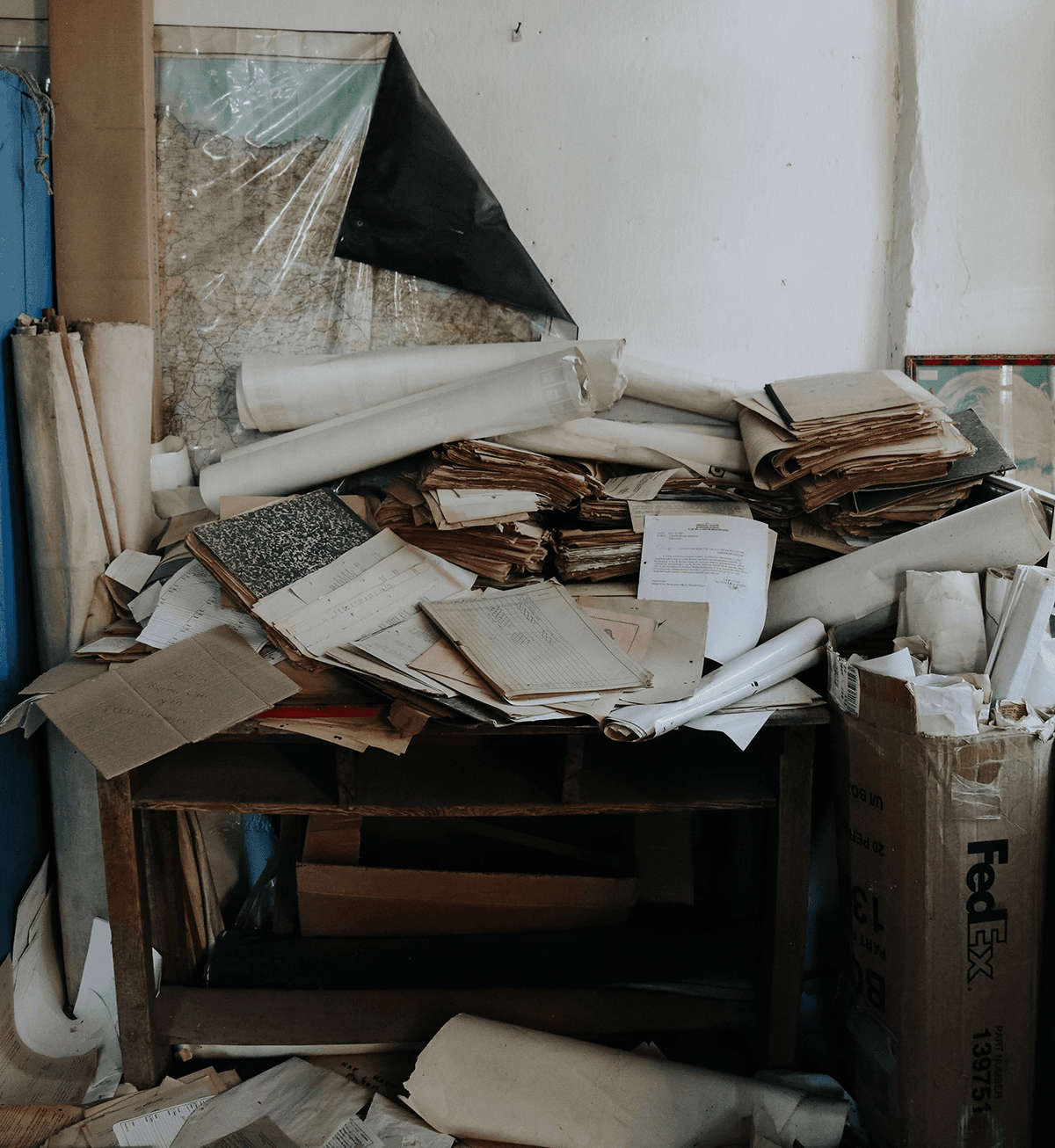 A school office desk buried in scattered paper records